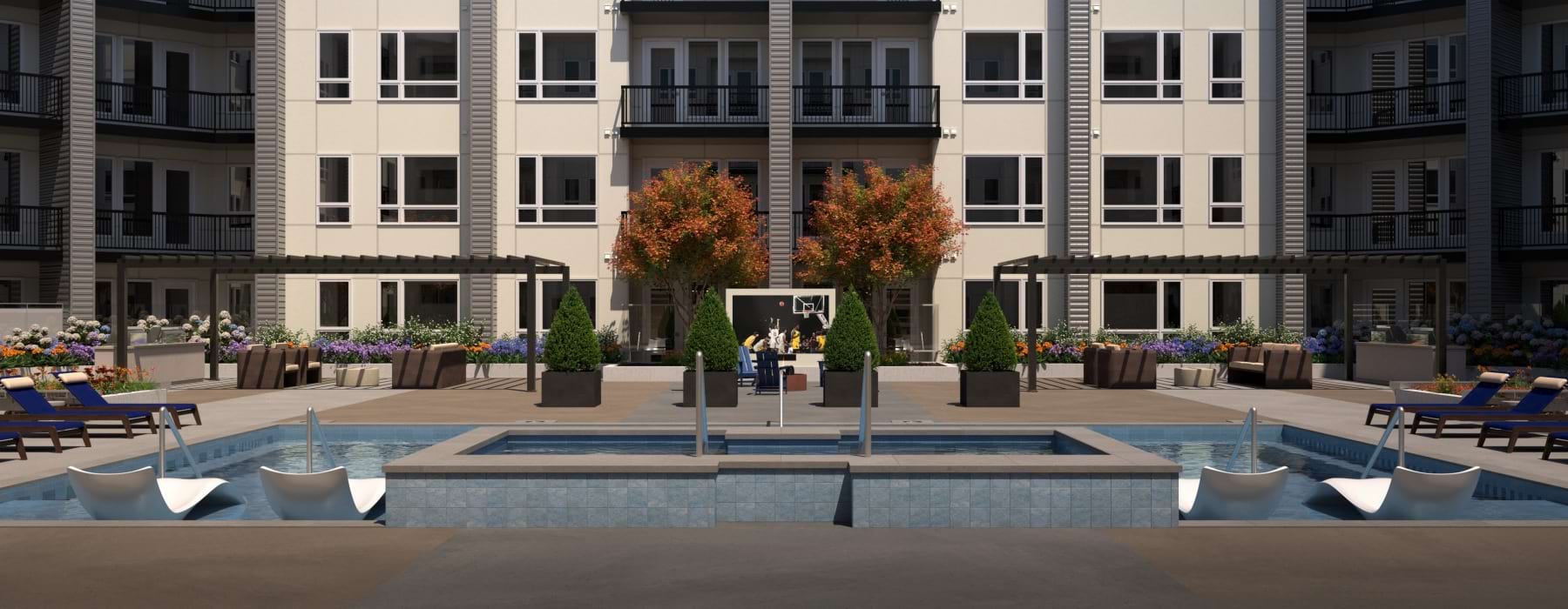 Expansive resort style pool in apartment resident courtyard with seating and mountain views in Murray UT