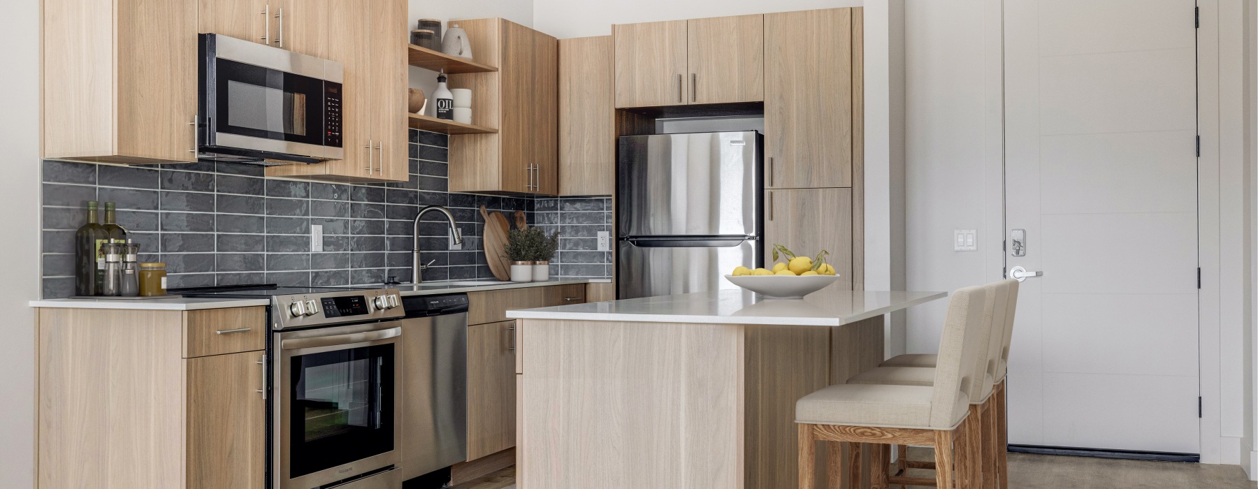 A luxury high end apartment kitchen with stainless steel appliances in Murray UT