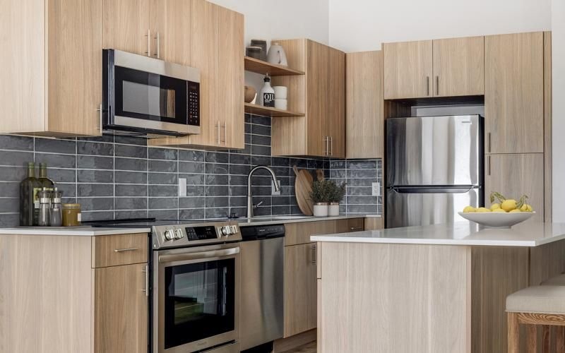 a kitchen with a stainless steel refrigerator
